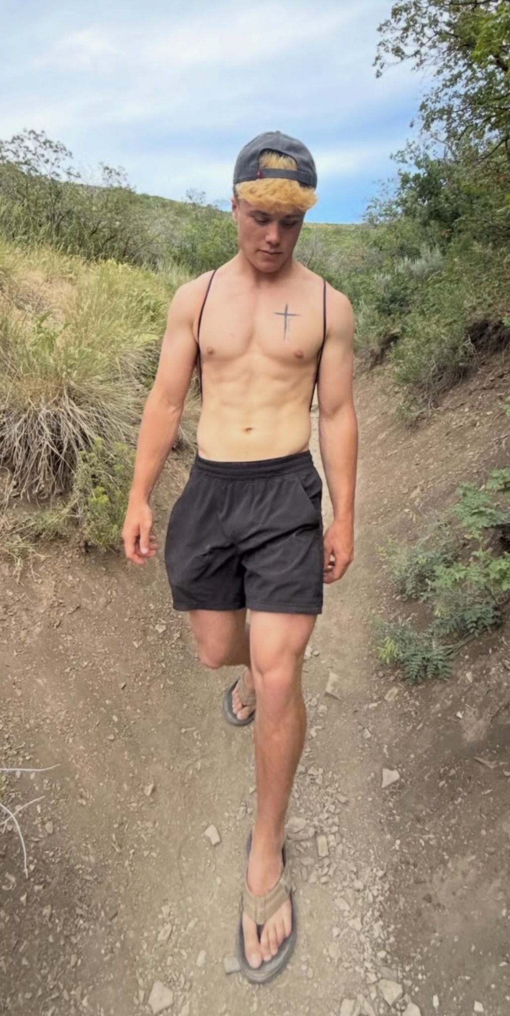 Cole walking along a hillside trail